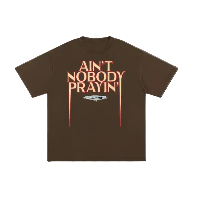 Brown t-shirt with red text 'Ain't Nobody Prayin'' on a white background